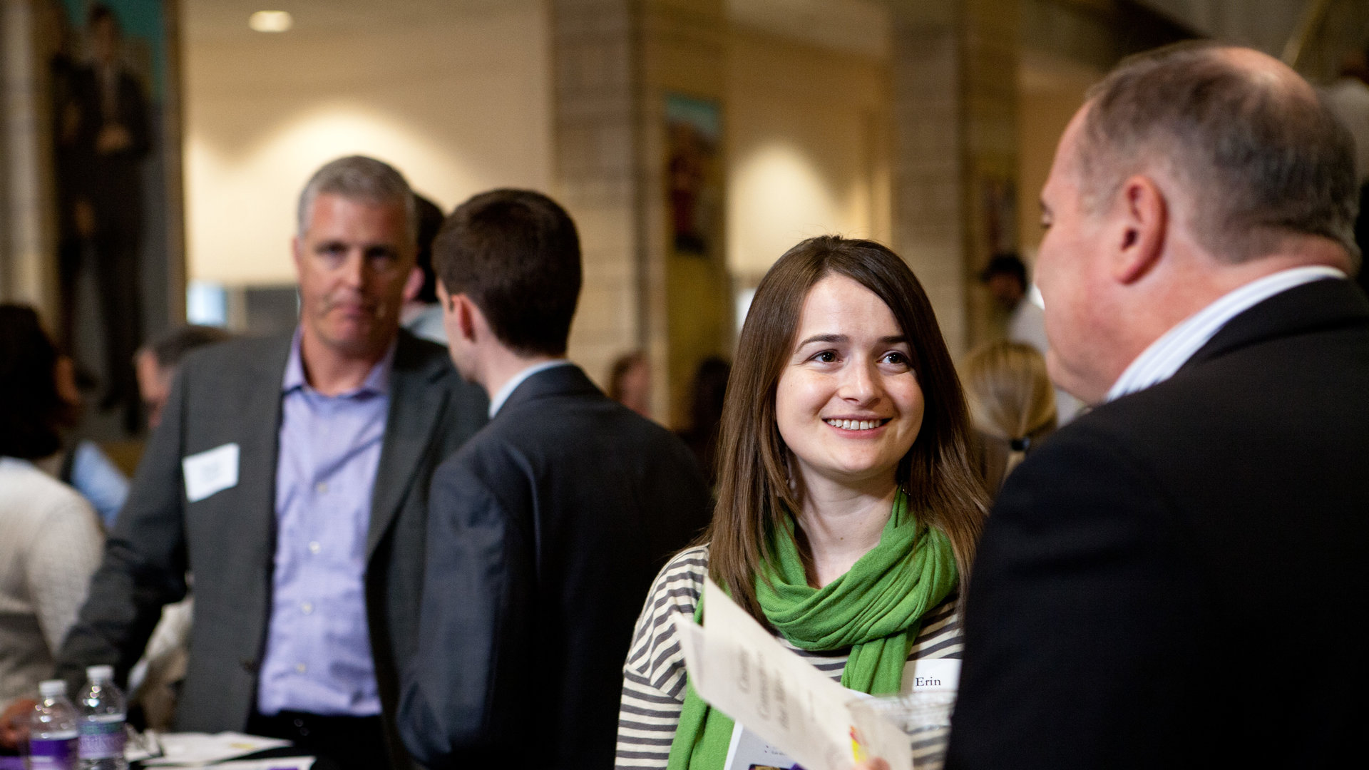 a woman speaking with a man at a st. thomas networking event