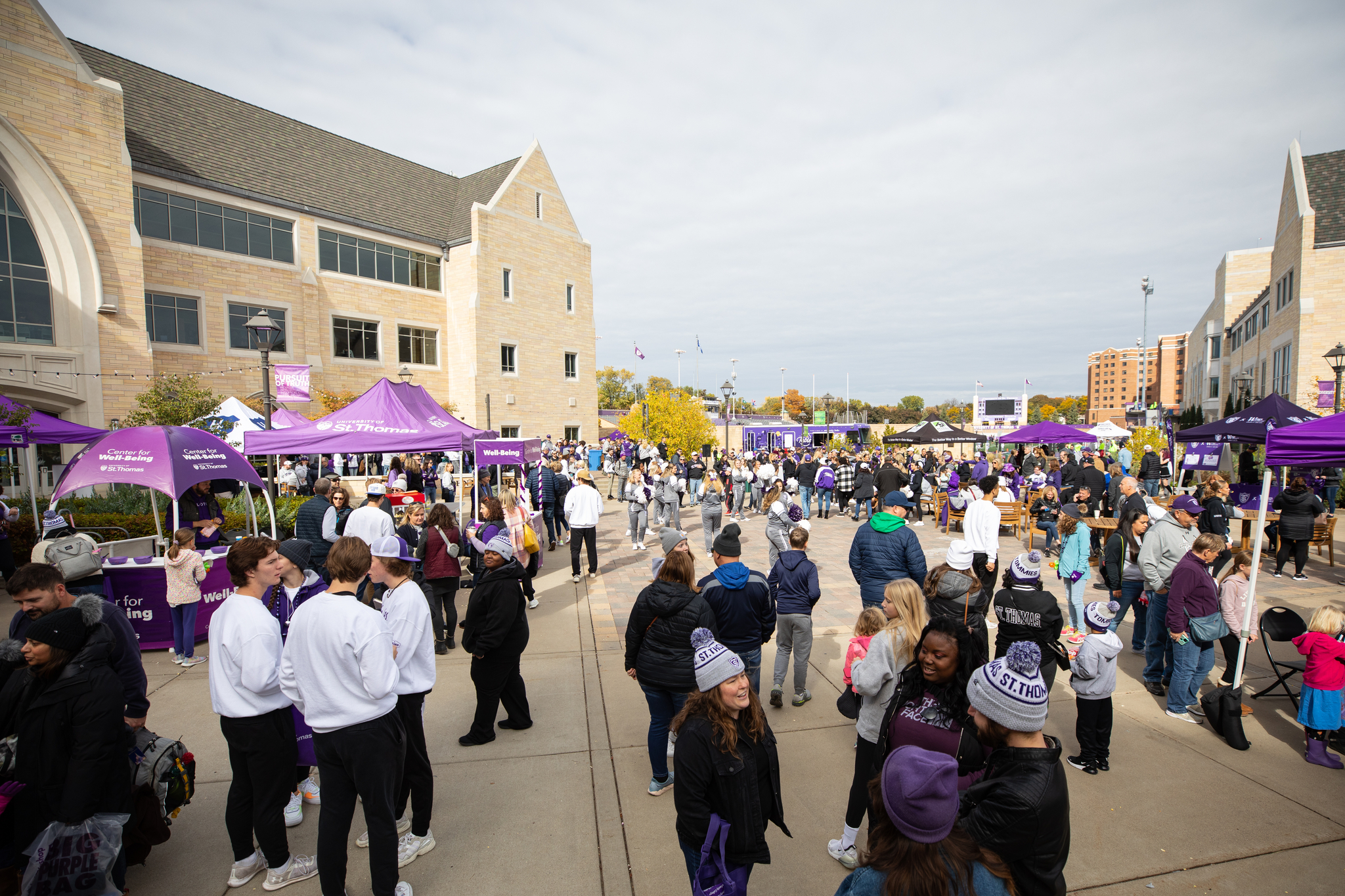Attendees socialize during Homecoming Purple on the Plaza