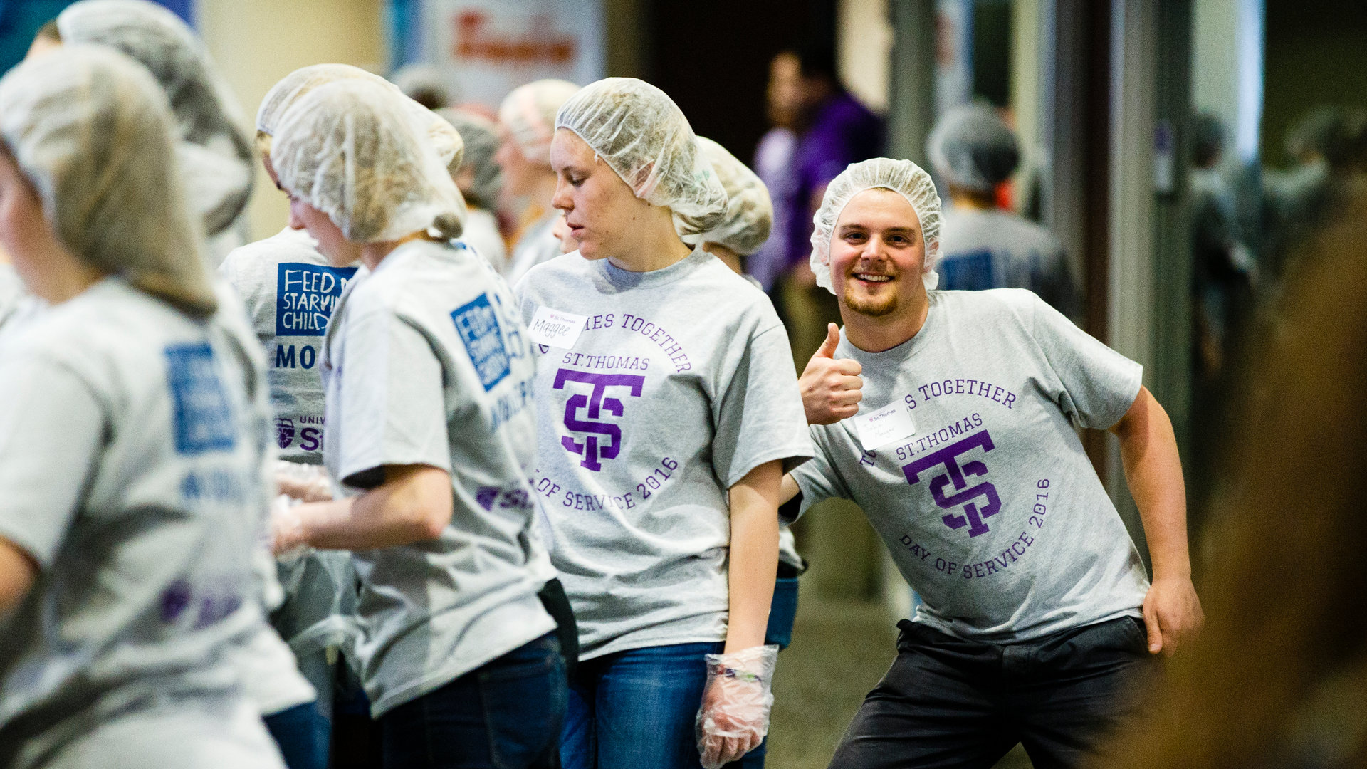 A culture of service starts with the students (shown here packing meals for Feed My Starving Children), who then continue to serve as alumni.