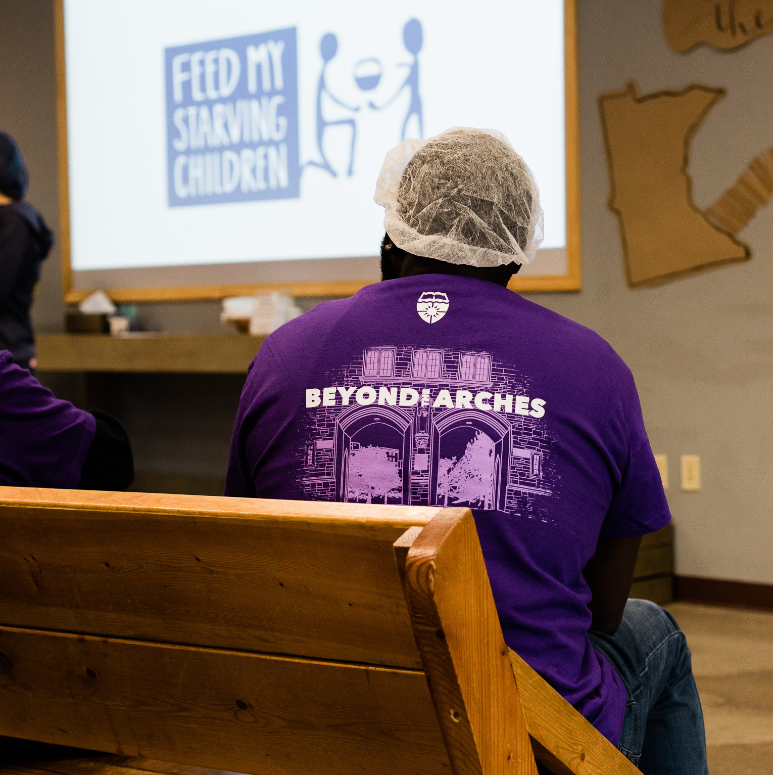 a 3M employee watches a demonstration at a Feed My Starving Children event