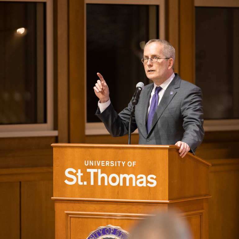 President Rob Vischer speaking at a St. Thomas podium