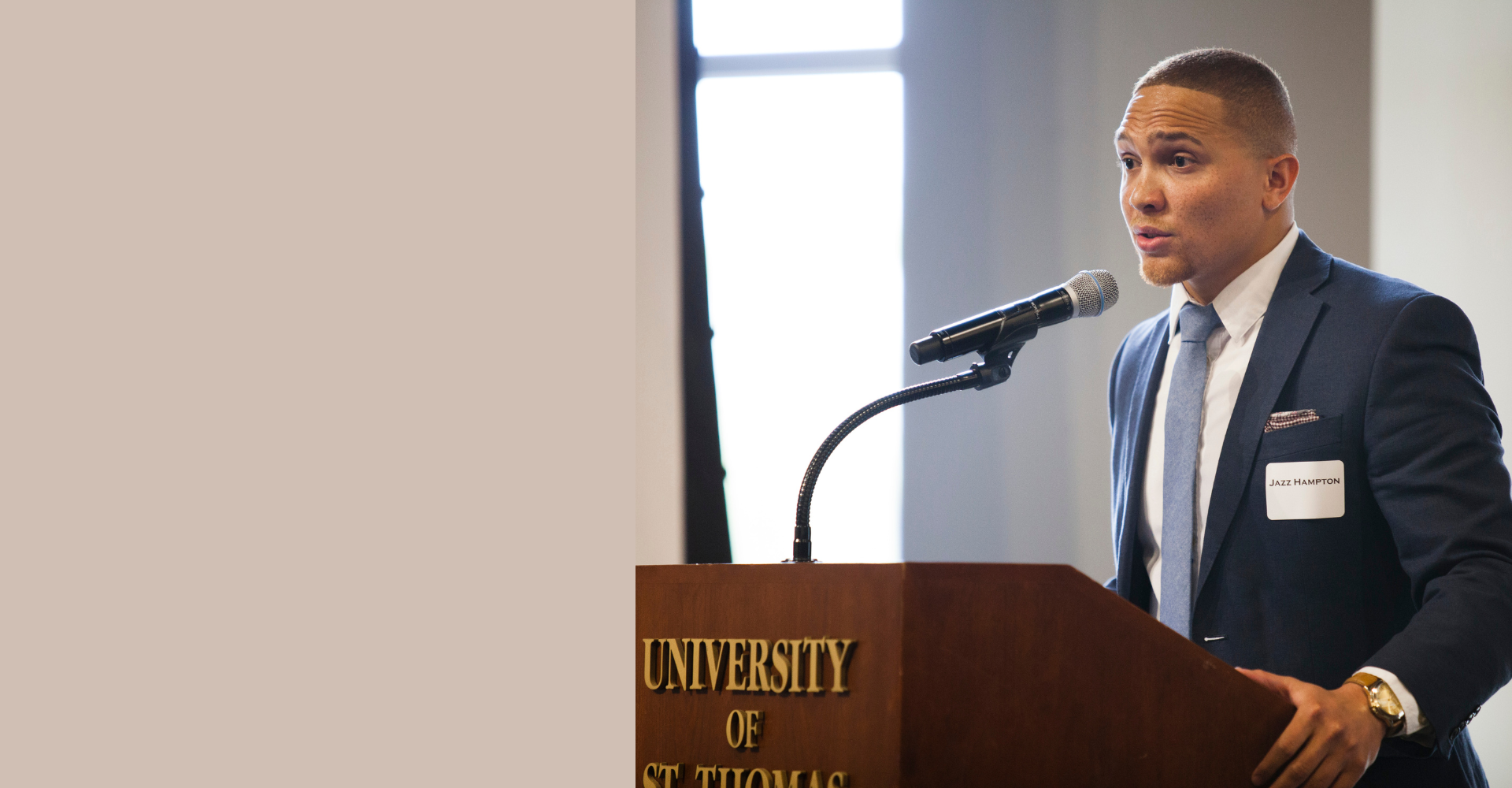 Jazz Hampton speaking at a podium at a University of St. Thomas event