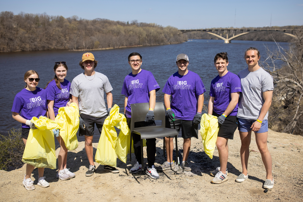 Members of the St. Thomas community clean up the river area together