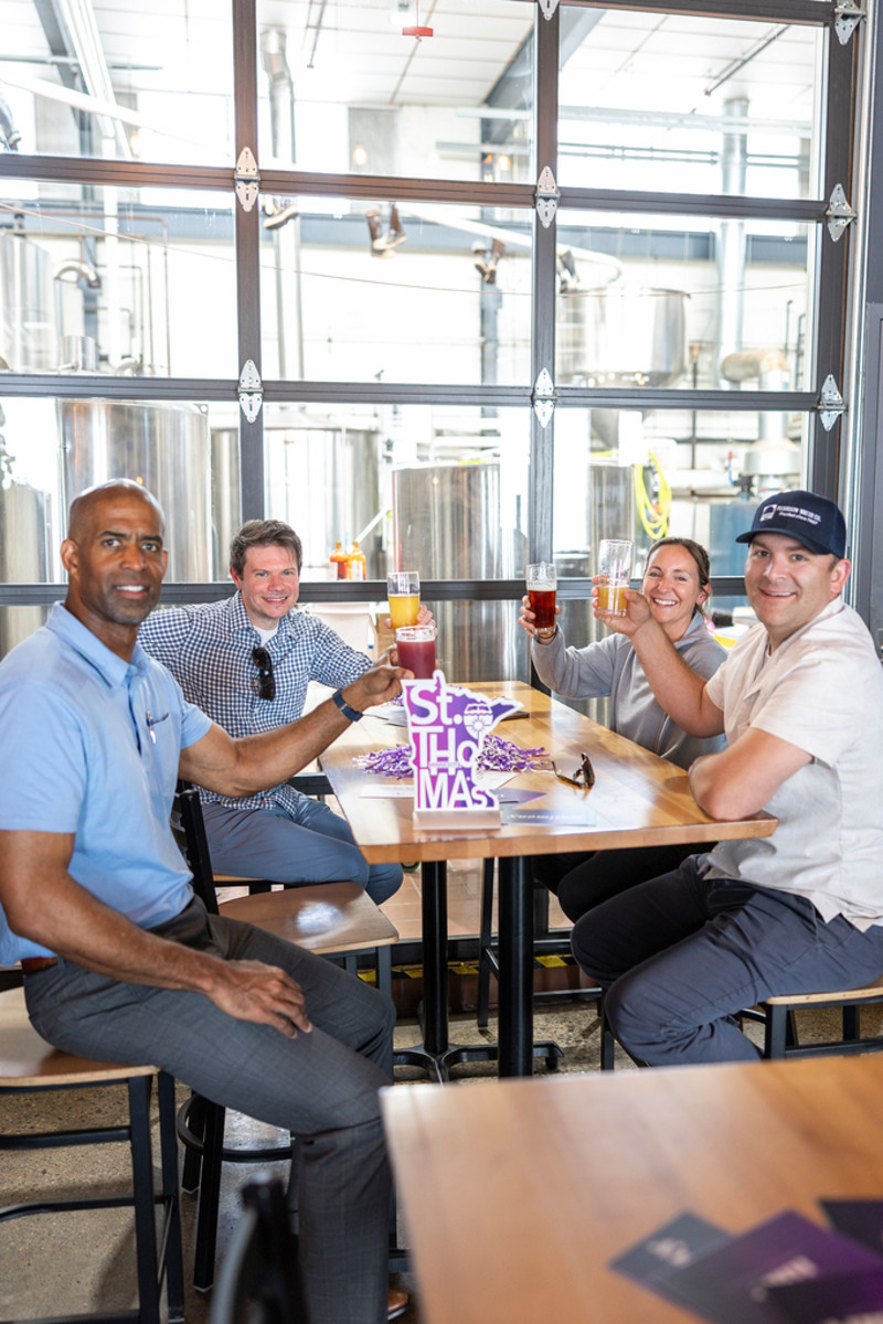 Tommie alumni gathered at a table at Insight Brewing