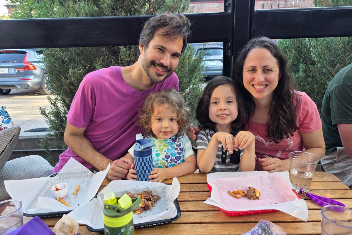 a family smiles for a photo while eating ice cream
