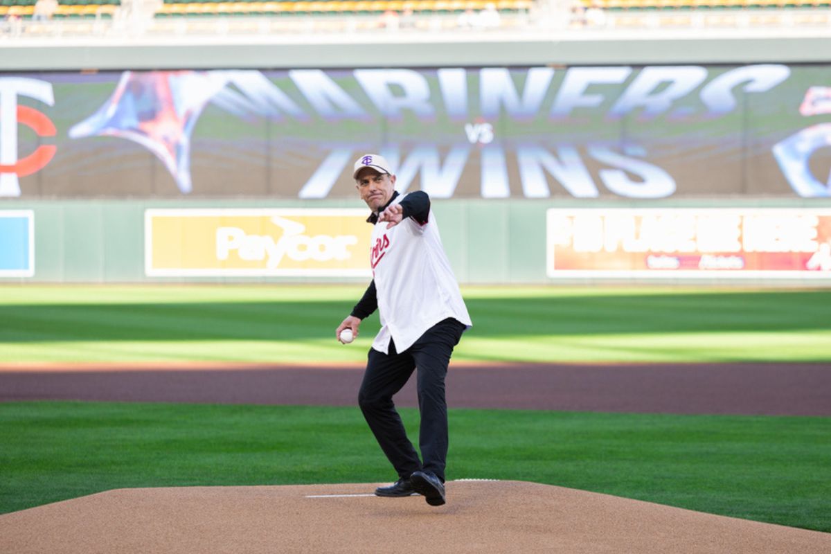 Father Collins throws the first pitch at Target Field