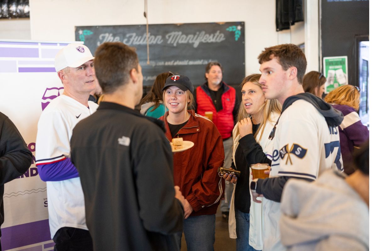 President Vischer talks with a group of students at Night with the Twins