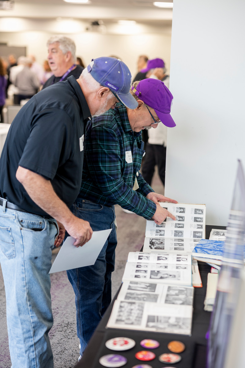 Purple Guard members picking up swag at the event