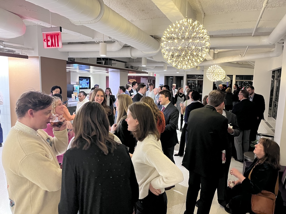 A round chandelier hangs over the attendees at TOTR NYC 2026