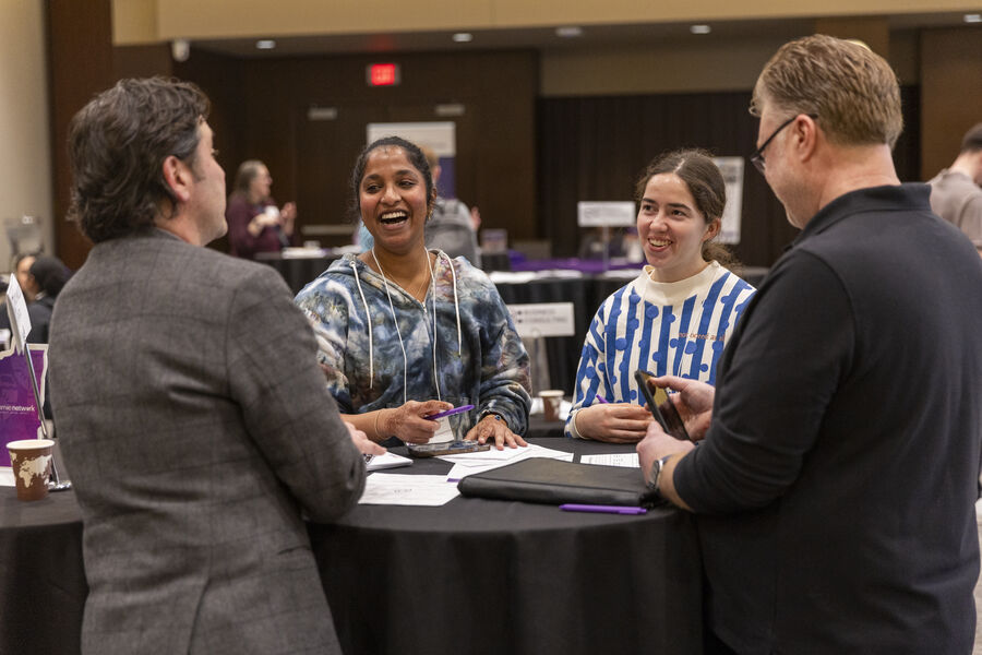 Students and alumni networking in Woulfe Hall.