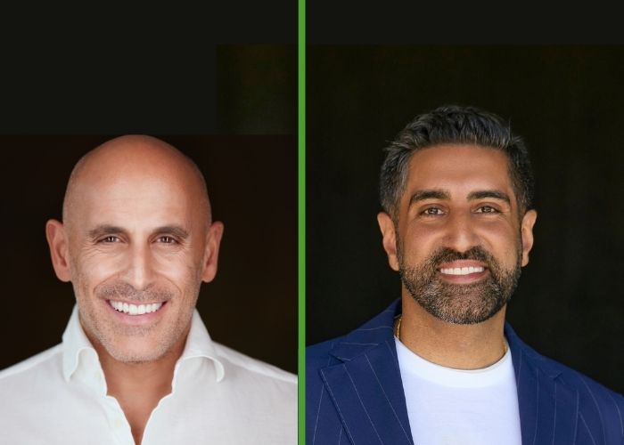 Marc Lore and Vik Uppal smile into the camera for headshots taken against black backgrounds