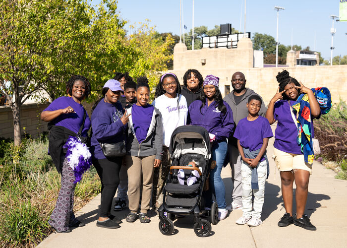 Family poses on Monahan Plaza during Family Weekend. 