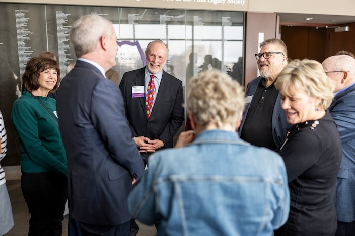 President Vischer talks with alumni during Homecoming weekend outside of James B. Woulfe Alumni Hall.