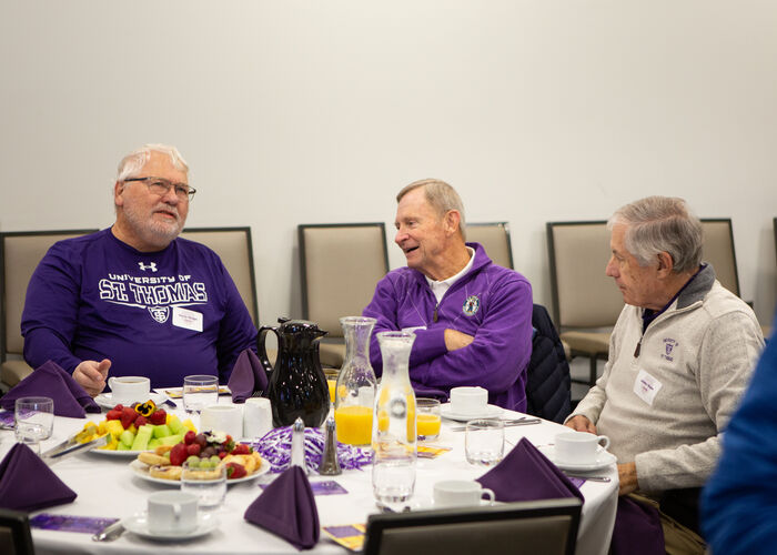 Three alumni talk over brunch at the Purple Guard brunch in 2025.