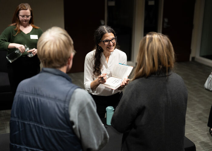 Rabbi Sharon Brous signs a copy of her book for a Finding Forward event attendee.