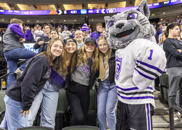 St. Thomas fans with Tommie mascot during game at Xcel Energy Center