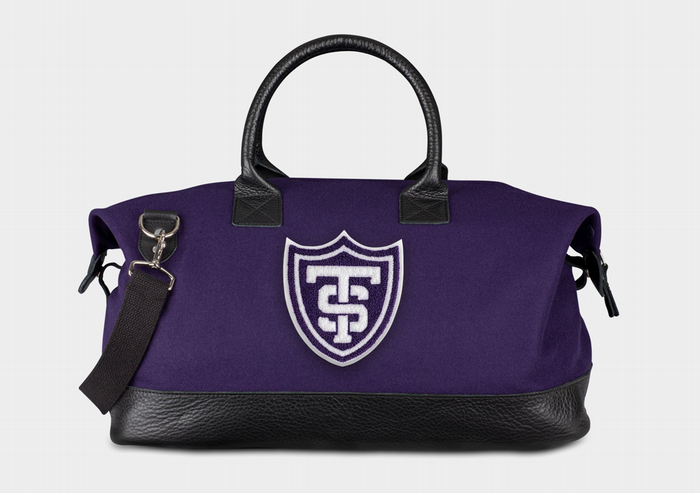 A purple weekender bag with the St. Thomas shield