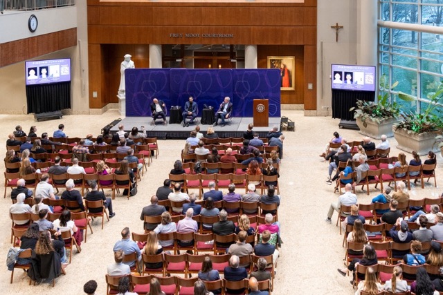 An aerial view of the crowd at Finding Forward captures attendees, speakers, and the atrium of the Law School
