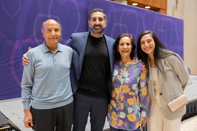 Vik Uppal poses on stage after Finding Forward with his family
