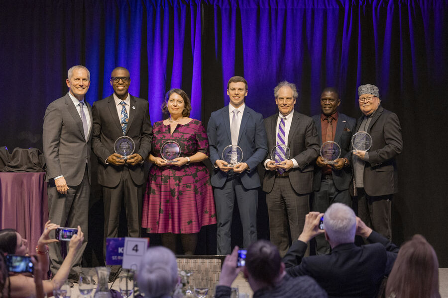 St. Thomas Day 2025 honorees on stage with President Vischer.