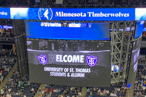 The jumbotron at the Target Center that says Welcome St. Thomas Alumni