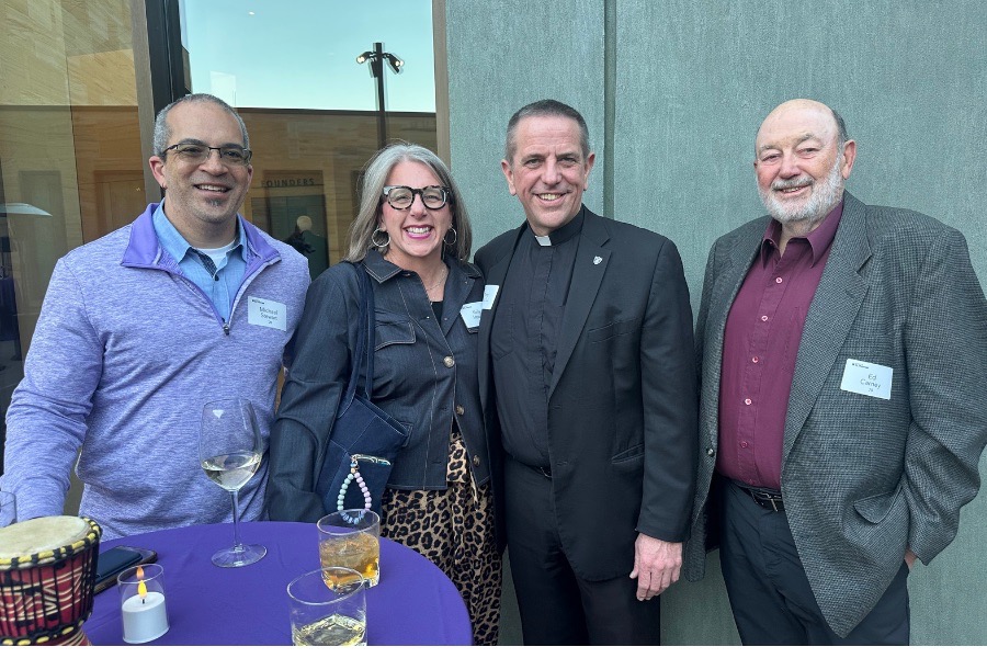 Father Chris and four TOTR attendees smile for a group photo in the courtyard of the Musical Instrument Museum.