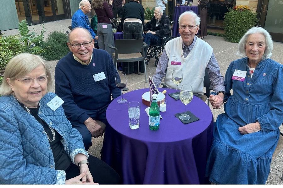 Four TOTR Phoenix sit at purple tables in the courtyard at the Musical Instrument Museum and smile at the camera while chatting over dinner.