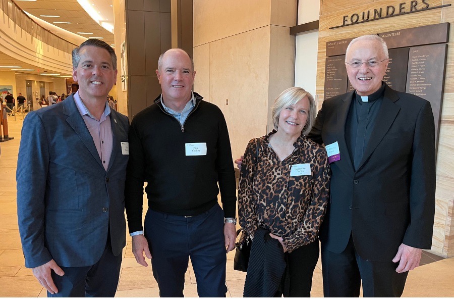 Vice President of Advancement Erik Thurman poses with St. Thomas trustees and TOTR event attendees.