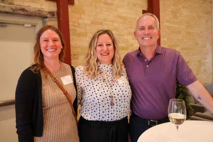 President Vischer poses for a photo with two Tommies