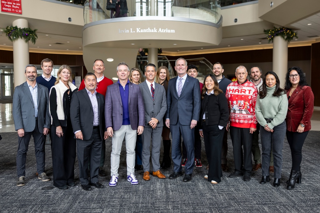 the alumni engagement board poses for a group photo on the steps in anderson student center