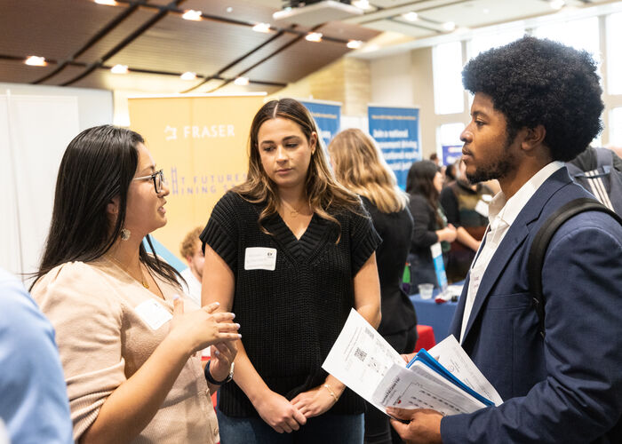 Students talking with prospective employers at the career fair.