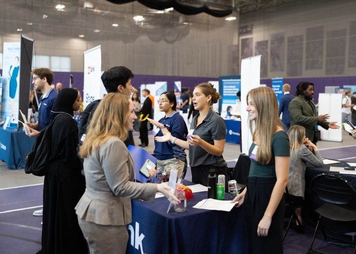 Students and employers talk during fall career fair.