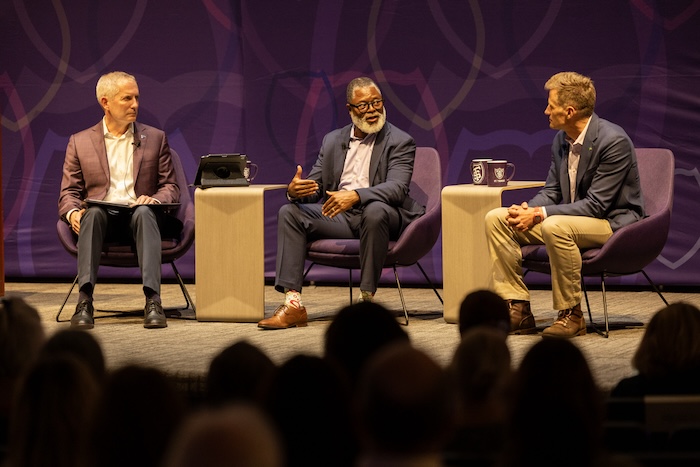 Duchesne Drew of Minnesota Public Radio, Star Tribune Publisher Steve Grove, and University of St. Thomas President Rob Vischer talk on stage at Finding Forward.