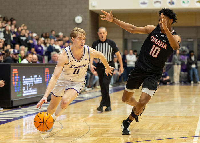 Drake Dobbs dodges an Omaha player during a Men’s Basketball game vs The University of Omaha, Nebraska on February 15, 2025, in Schoenecker Arena in St. Paul.