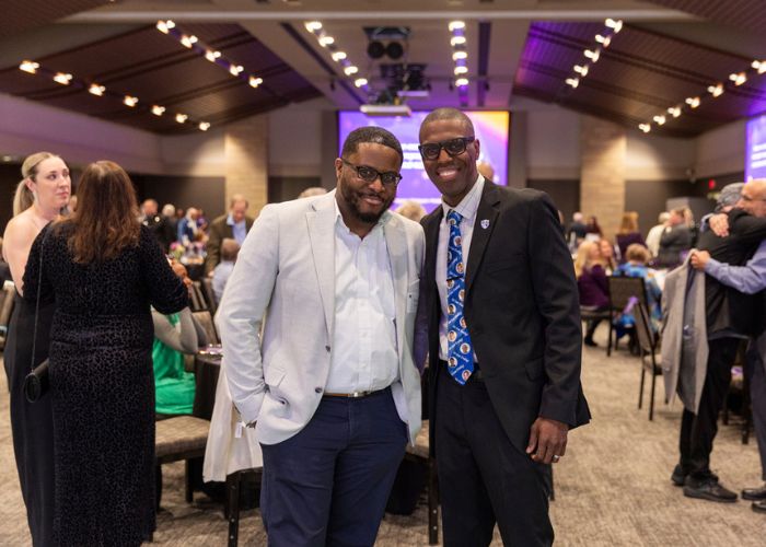 Two people at St. Thomas Day awards program.
