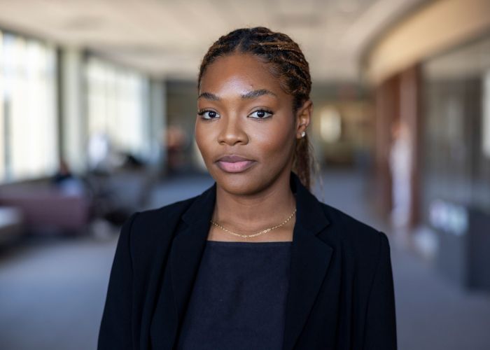 Rachel Obeakemhe ’26 looks into the camera for a portrait taken outside of Woulfe Alumni Hall