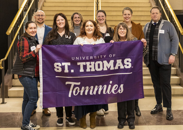 Tommies in Washington, D.C. pose for a photo in front of stairs.