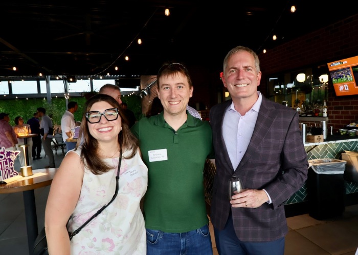 Two Tommies stand with President Vischer for a photo