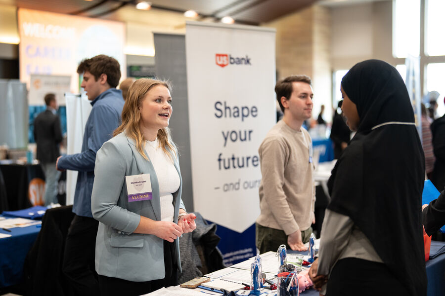 Students speaking to companies at a career fair