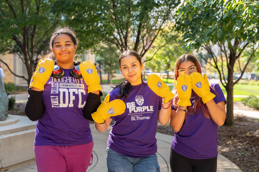DFC students pose on Minneapolis campus wearing branded Tommie choppers