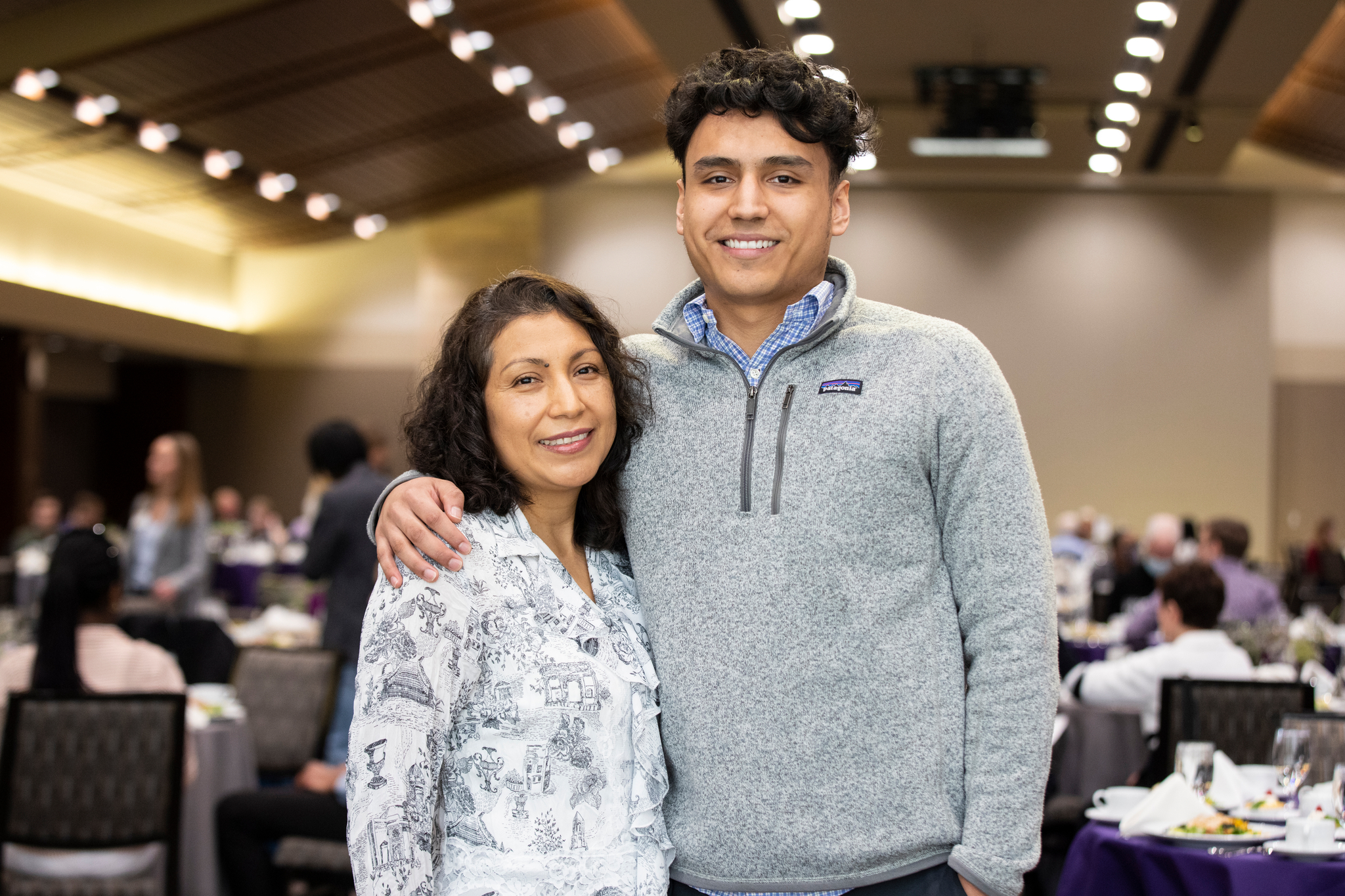Student stands for a photo with his mother during the annual Scholarship Spotlight luncheon