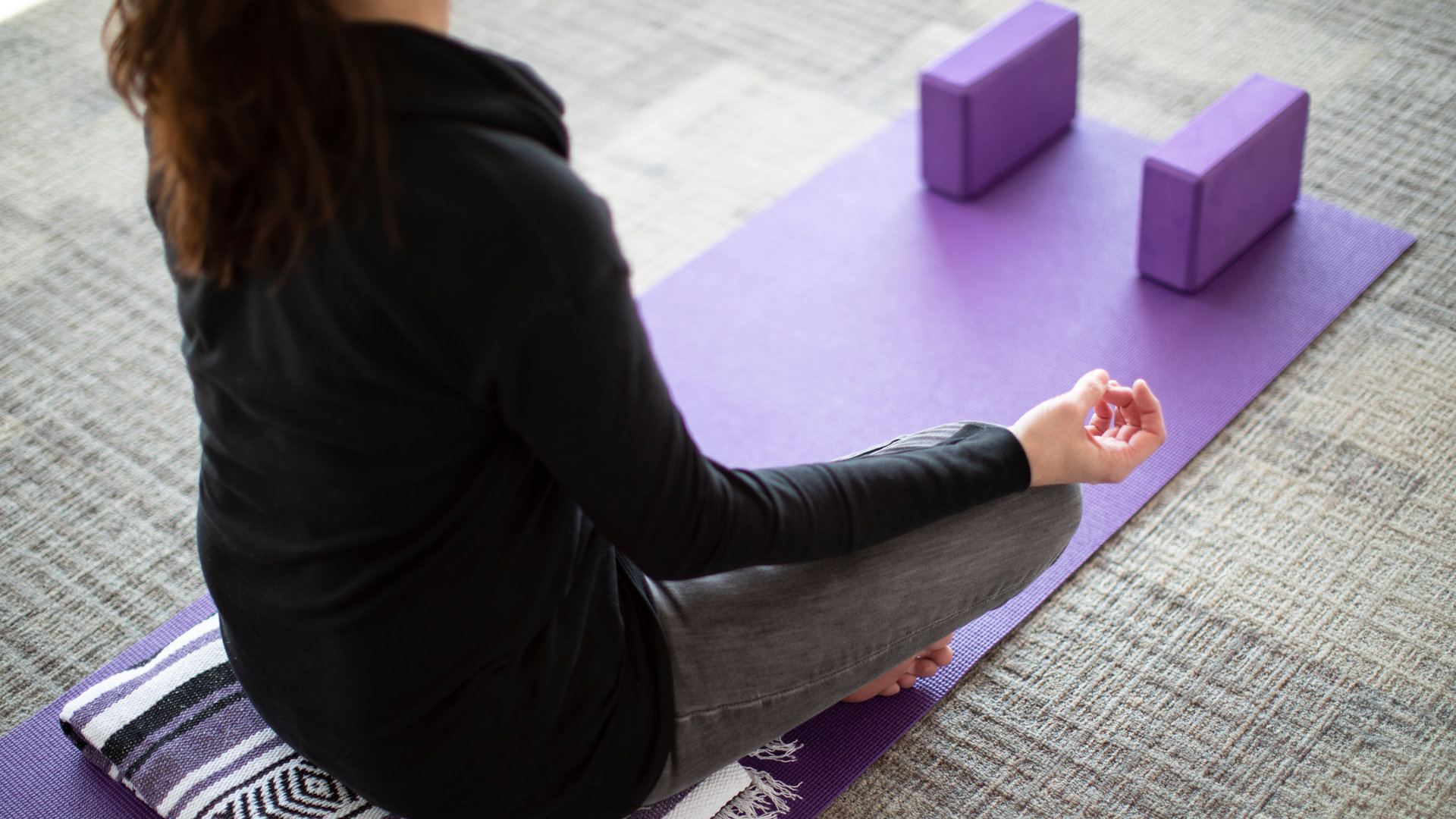 a woman meditates in the Center for Well-Being