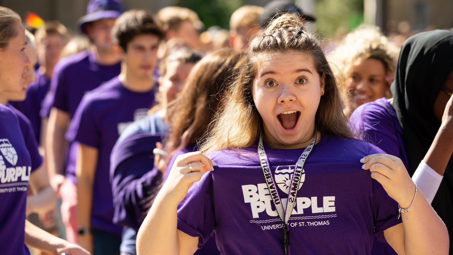 a student displays her purple pride t-shirt at March Through the Arches