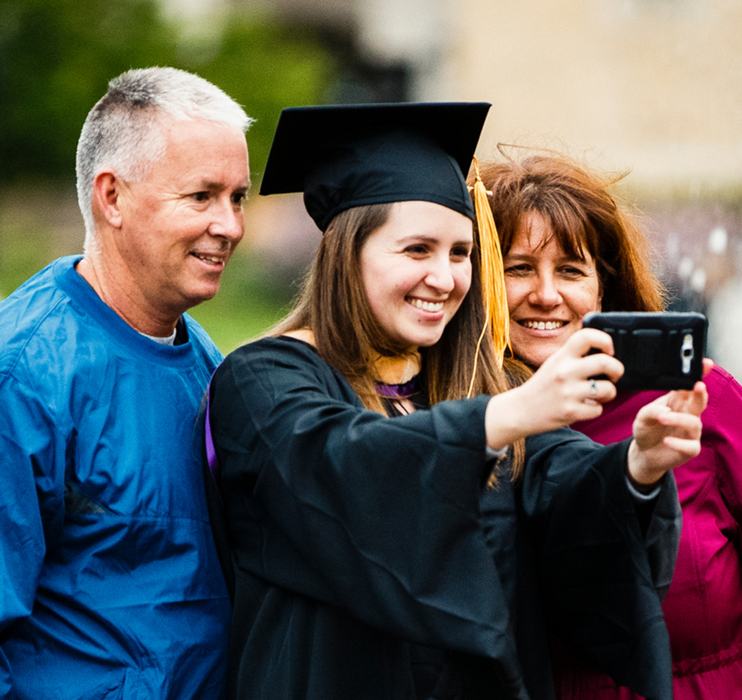 Parents taking a selfie with their graduate
